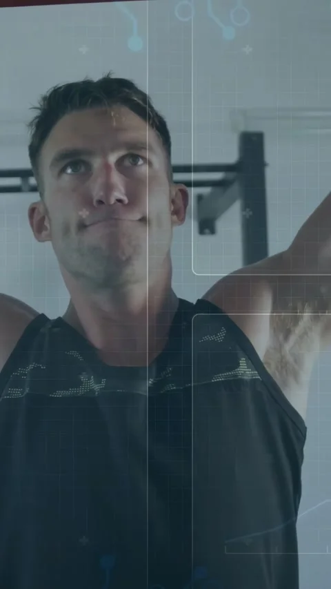 Bracing man pulling up red-pull-up-bar for fitness at gym, black patterned Stock Footage 334381784