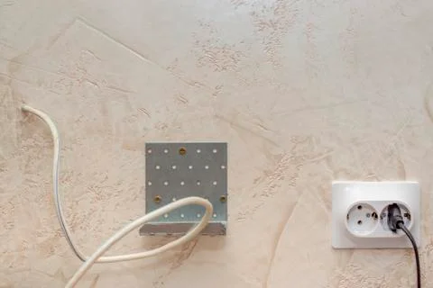 Bracket and sockets on wall for mounting and connecting TV device Stock-Fotos