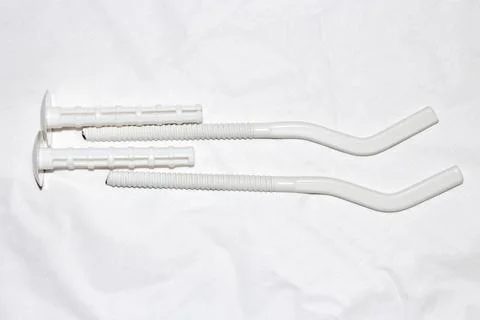 Brackets for the heating battery.Metal brackets with plastic dowel plugs. Stock Photos