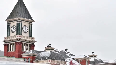 Bradford Pa clock tower close up during fresh snow storm Stock Footage 257455061