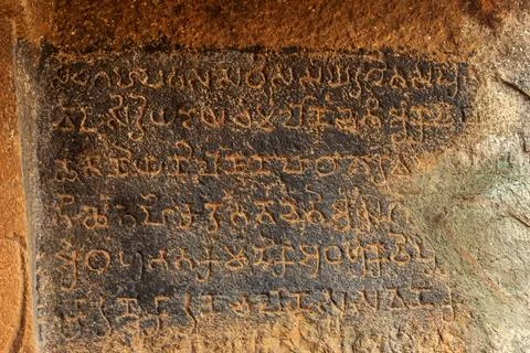 Brahmi Script in Cave 27, Gandharpale Buddhist caves. Group of 30 Buddhist... Stock Photos