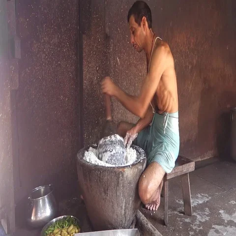 Brahmin presses rice in a large pot in the kitchen of a Hindu temple Stock Footage 69313356