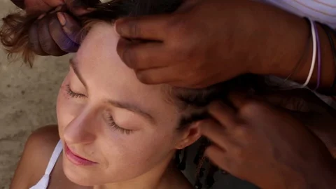 Braid dreadlocks. Three pairs of hands braid pigtails. Stock Footage 129848109