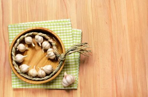 Braid of garlic on wooden table. Stock Photos