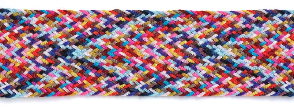 A braid of multi colored sewing threads on a white background Fotos de archivo