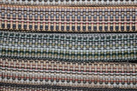 Braid with ornament.Decorative braid - woven multi-colored threads. Braid is Stock Photos