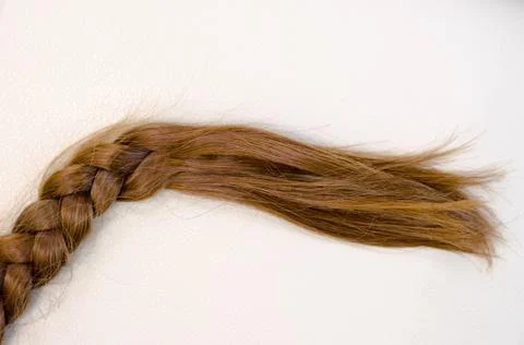 Braid of red hair on a beige background Stock Photos