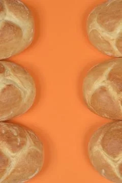 Braided Bread Rolls on Orange Background Foto stock