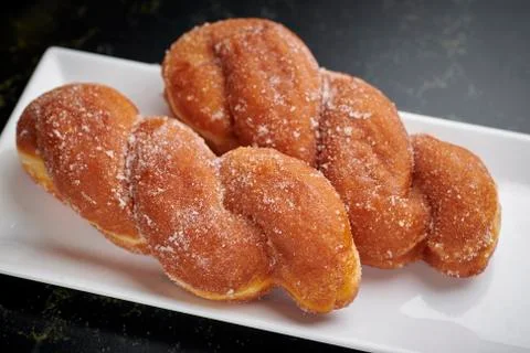 Braided brioches on a white rectangular plate Foto stock