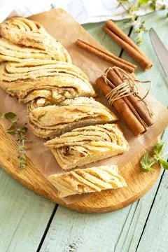 Braided cinnamon sweet bread on rustic wooden board with cinnamon sticks an.. Stock Photos