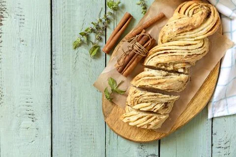 Braided cinnamon sweet bread on rustic wooden board with cinnamon sticks an.. Stock Photos
