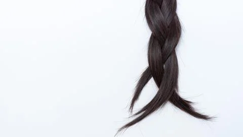 Braided dark hair with split ends displayed against a clean white background Stock Photos