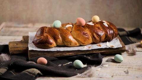 Braided Easter Bread with Pastel Speckled Eggs on Rustic Wooden Board Stock Photos