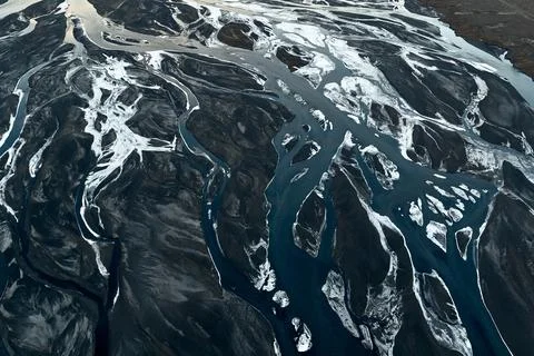 Braided glacier river channels creating abstract terrestrial patterns 写真素材