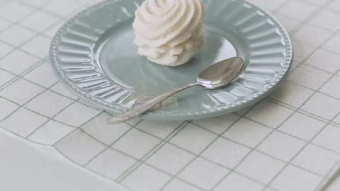 Braided marshmallow. White marshmallow on a turquoise plate and a silver spoon. Stock Footage 344833996