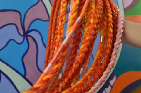 Braids on a color background at close range Stock Photos