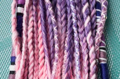 Braids on a wood background at close range Stock Photos