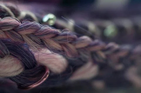 Braids on a wood background at close range Stock Photos