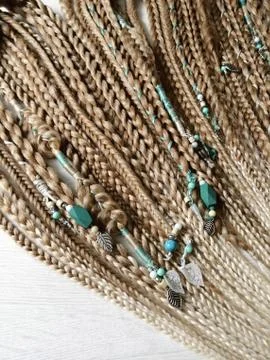 Braids on a wood background at close range Stock Photos