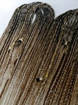 Braids on a wood background at close range Stock Photos