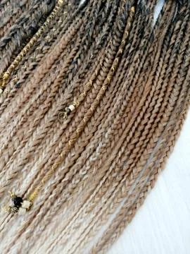 Braids on a wood background at close range Stock Photos