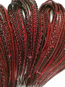 Braids on a wood background at close range Stock Photos
