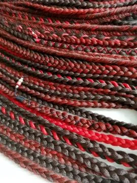 Braids on a wood background at close range Stock Photos