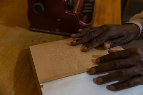 Braille reading session: a blind man's fingers on his book to read a passage Stock Photos