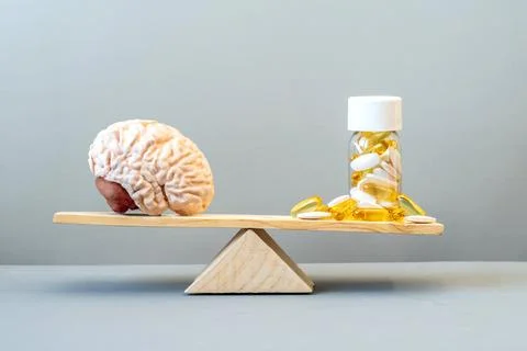 Brain and supplements on the Balance Scale. Medical addiction of the brain Photos