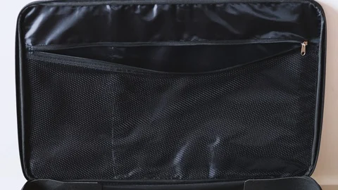 Brain drain concept, open suitcase with string of lightbulbs switched on symb Stock Footage 123741809