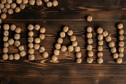 Brain inscription made of walnuts on a wooden background. Stock Photos