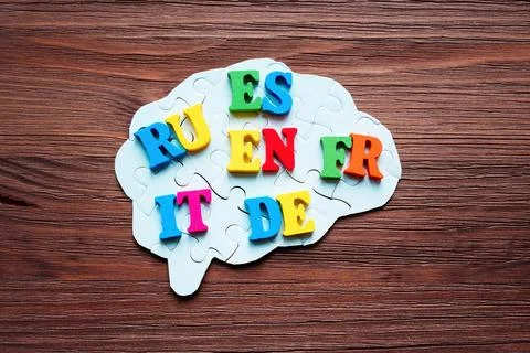 Brain Puzzle and Language Codes on Wooden Background Stock Photos