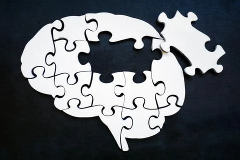 Brain from puzzle pieces with one missing. Memory problems and Alzheimer disease Stock Photos