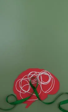 Brain shape with tangled string and green ribbon Stock Photos