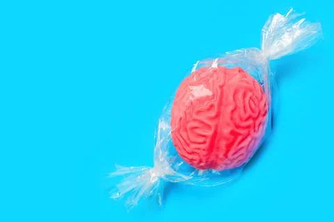 Brain-shaped Candy Wrapped in a Plastic Cover on Blue Stockfoto's