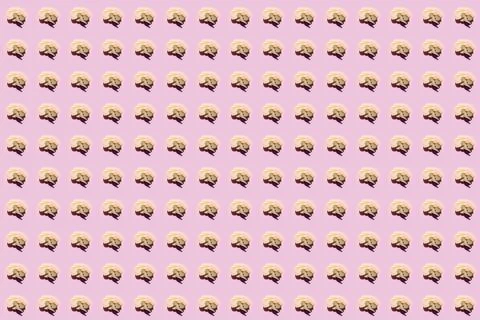 Brain-shaped cookie pattern on pink background arranged in a neat grid for Stock Photos