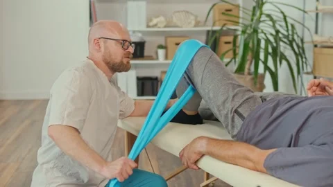 A Brain Stroke Patient Uses Physical Therapy to Restore and Increase Mobility. Stock Footage 163550396