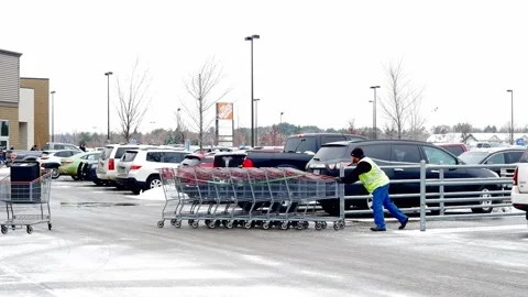 BRAINERD, MN - 26 DEC 2019: A Costco cart attendant is working in winter Stock Footage 131486103