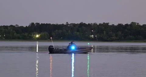 BRAINERD, MN - 9 AUG 2024: Sheriff boat on lake with flashing lights Stock Footage 290135582