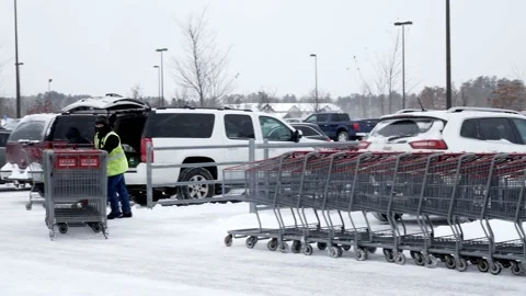 BRAINERD, MN - 9 DEC 2019: A Costco cart attendant working in parking lot. Stock Footage 141833924