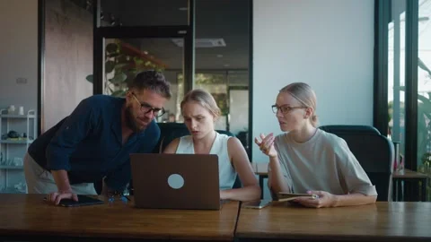 Brainstorm over serious project are collaborating on project, gathered around Stock Footage 312122395