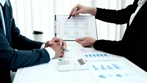 Brainstorming and Business Consulting, Marketer presents Graph data and plan Stock Footage 194756659