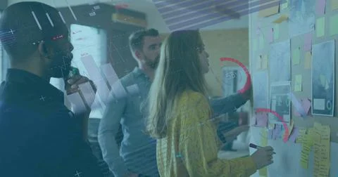 Brainstorming colleagues writing sticky notes on board at office, with diagrams Stock Photos