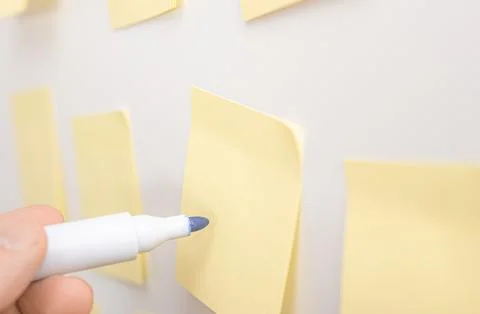 Brainstorming for strategy plan. hand with marker writes on note. Yellow st.. Stock Photos