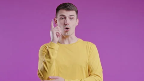 Brainy man having idea eureka moment, pointing finger up on pink. Solution. 動画素材 241159978