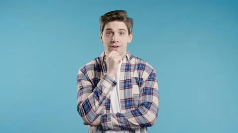 Brainy man having idea eureka moment, pointing finger up on blue. Solution. 動画素材 276226096