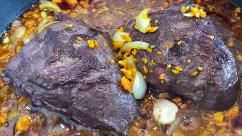 Braised beef cheeks in brown red wine sauce with herbs Stock Footage 277602139