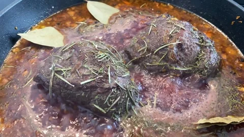 Braised beef cheeks in brown red wine sauce with herbs Stock Footage 277602323