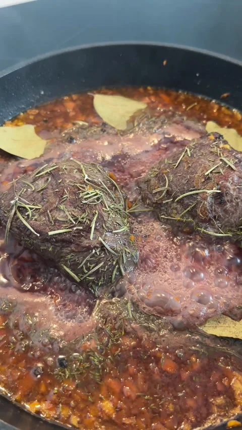 Braised beef cheeks in brown red wine sauce with herbs Stock Footage 277695788