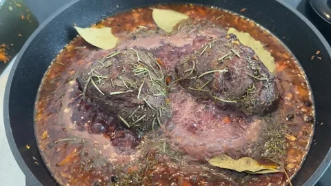 Braised beef cheeks in a pan Stock Footage 277611115